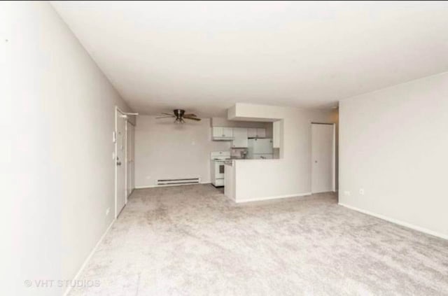 633 Virginia Rd Unit 214, Crystal Lake, IL 60014 - unfurnished living room with baseboard heating, light colored carpet, and a ceiling fan