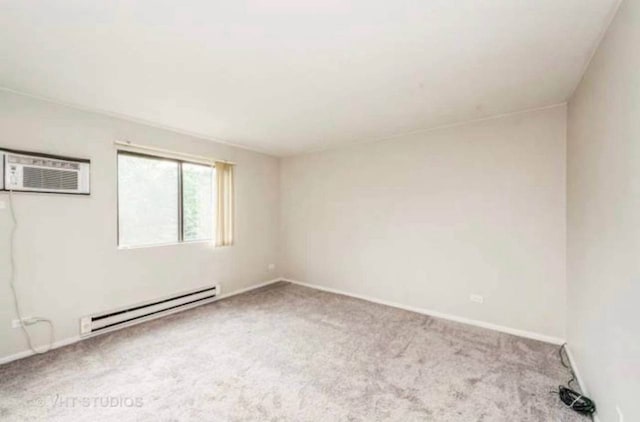 633 Virginia Rd Unit 214, Crystal Lake, IL 60014 - empty room with baseboard heating, a wall unit AC, and carpet flooring