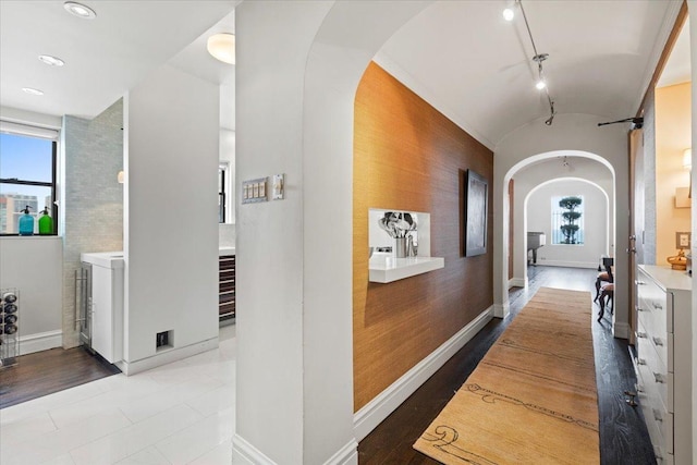 5510 N Sheridan Rd Unit 17A, Chicago, IL 60640 - corridor featuring arched walkways, plenty of natural light, washer and dryer, an accent wall, and lofted ceiling