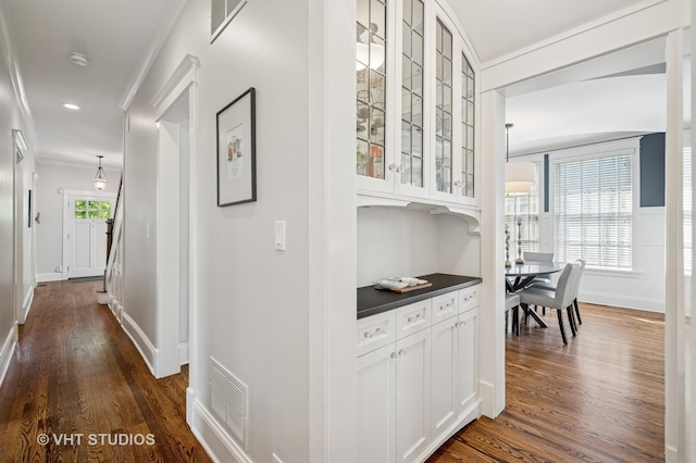 625 Park Ave, Wilmette, IL 60091 - hallway featuring dark wood-type flooring, ornamental molding, and recessed lighting