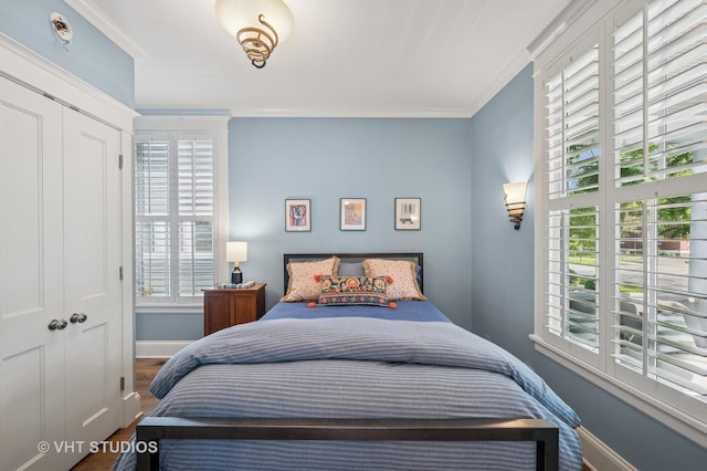 625 Park Ave, Wilmette, IL 60091 - bedroom with multiple windows, crown molding, and wood finished floors