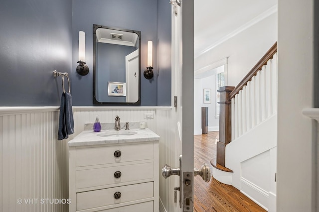 625 Park Ave, Wilmette, IL 60091 - bathroom featuring vanity, wood finished floors, wainscoting, and crown molding