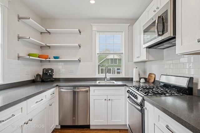 625 Park Ave, Wilmette, IL 60091 - kitchen with appliances with stainless steel finishes, dark countertops, white cabinets, decorative backsplash, and recessed lighting
