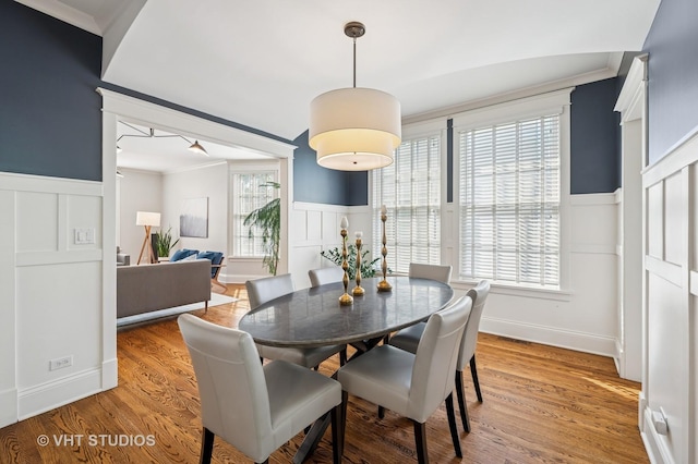 625 Park Ave, Wilmette, IL 60091 - dining space featuring ornamental molding, a wainscoted wall, a decorative wall, plenty of natural light, and light wood-style floors