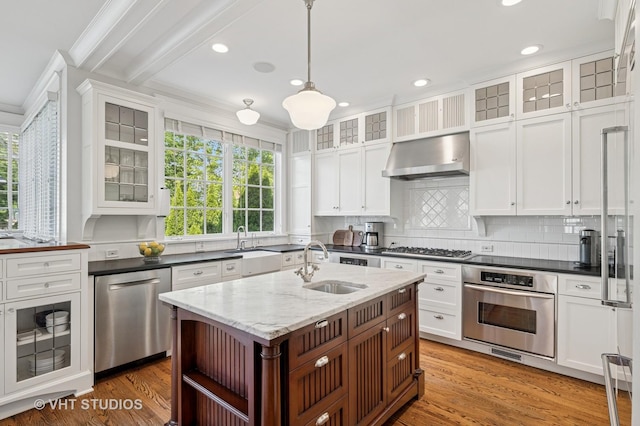 625 Park Ave, Wilmette, IL 60091 - kitchen featuring appliances with stainless steel finishes, wall chimney exhaust hood, open shelves, light wood-type flooring, and pendant lighting