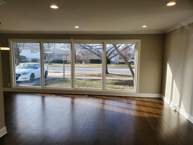 542 Laramie Ave, Wilmette, IL 60091 - empty room with dark wood finished floors, ornamental molding, and recessed lighting