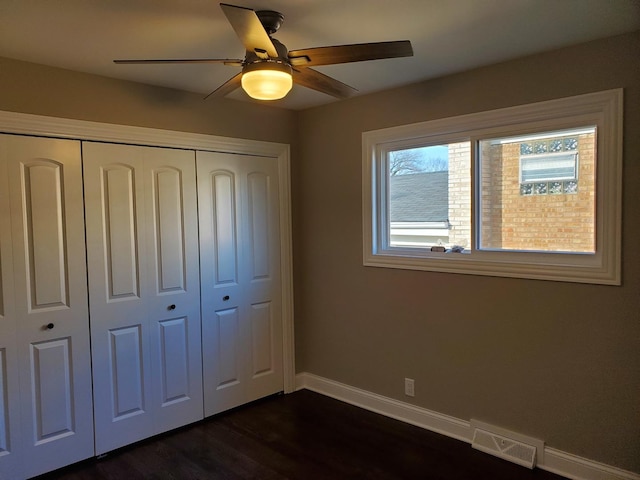 542 Laramie Ave, Wilmette, IL 60091 - unfurnished bedroom with a closet, dark wood-style flooring, and a ceiling fan