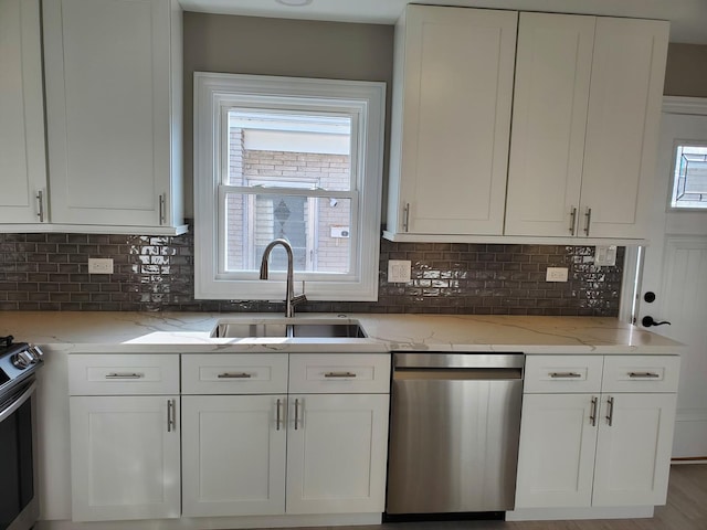 542 Laramie Ave, Wilmette, IL 60091 - kitchen with stainless steel dishwasher, stove, white cabinetry, and light stone countertops