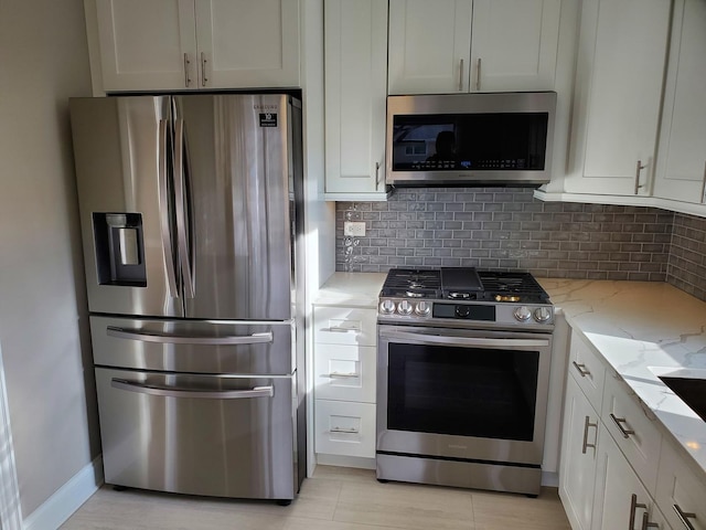 542 Laramie Ave, Wilmette, IL 60091 - kitchen with stainless steel appliances, light stone counters, decorative backsplash, and white cabinets