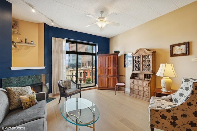 1301 W Washington Blvd Unit 509, Chicago, IL 60607 - living room featuring ceiling fan, wood finished floors, track lighting, and a fireplace