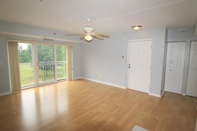 7335 Oakwood Ave Unit 4F, Lyons, IL 60534 - unfurnished living room featuring light wood-style floors and a ceiling fan