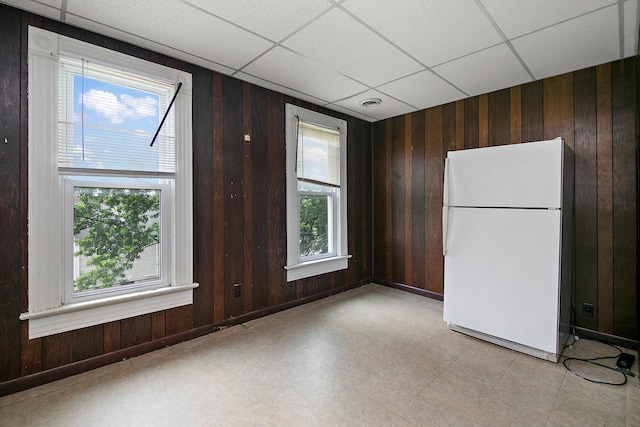 125 S Main St, Clifton, IL 60927 - empty room with a paneled ceiling, wooden walls, and light floors