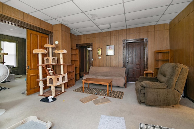 125 S Main St, Clifton, IL 60927 - living area with wood walls, carpet, and a paneled ceiling