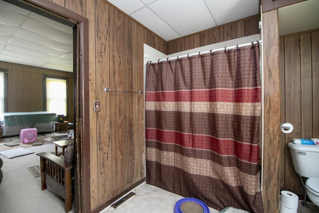125 S Main St, Clifton, IL 60927 - full bathroom with wood walls, tile patterned floors, and a shower with curtain