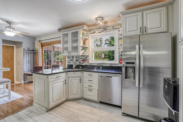 15005 131st St, Lemont, IL 60439 - kitchen with stainless steel appliances, a sink, a peninsula, a ceiling fan, and light wood finished floors