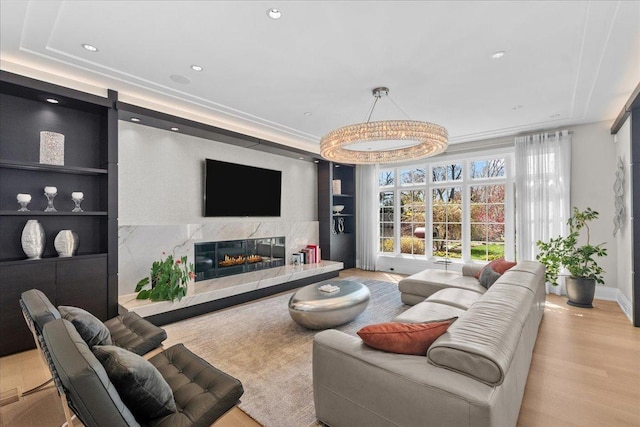 326 Country Ln, Glenview, IL 60025 - living room featuring built in shelves, a raised ceiling, wood finished floors, a premium fireplace, and recessed lighting
