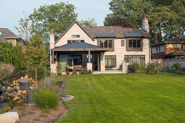 326 Country Ln, Glenview, IL 60025 - back of property featuring a standing seam roof, a patio, a metal roof, stucco siding, and a chimney