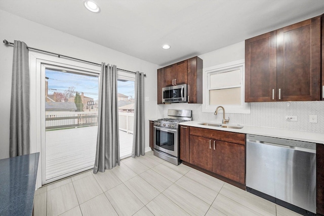3100 N Newcastle Ave, Chicago, IL 60634 - kitchen featuring appliances with stainless steel finishes, dark brown cabinets, light countertops, light tile patterned flooring, and backsplash