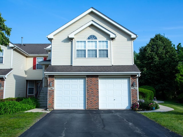 7367 Grandview Ct Unit 7367, Carpentersville, IL 60110 - view of front of home featuring brick siding, asphalt driveway, an attached garage, and a shingled roof