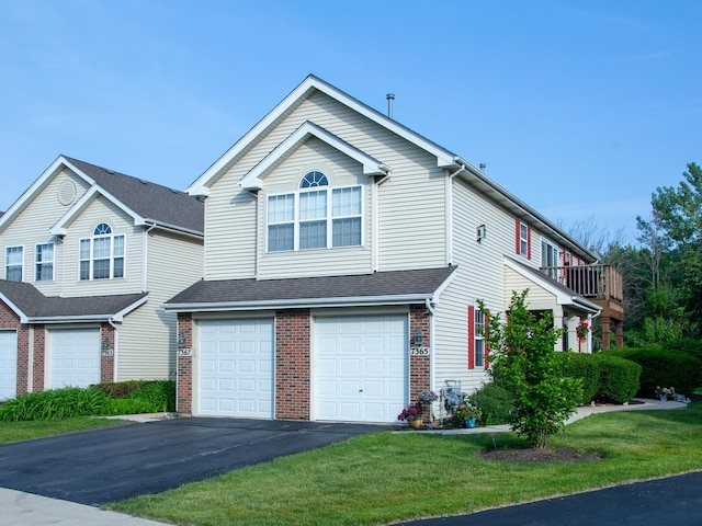 7367 Grandview Ct Unit 7367, Carpentersville, IL 60110 - view of front facade with asphalt driveway, a garage, brick siding, and a front lawn
