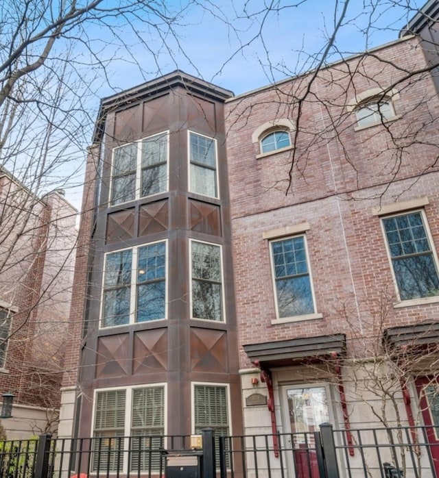 3019 W Cornelia Ave, Chicago, IL 60618 - view of front of home featuring a fenced front yard, brick siding, and a gate