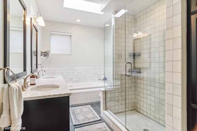 3019 W Cornelia Ave, Chicago, IL 60618 - full bath featuring a garden tub, double vanity, tile patterned floors, a shower stall, and a skylight