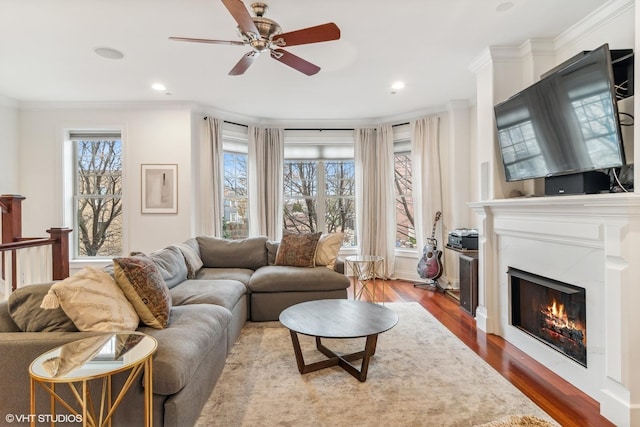 3019 W Cornelia Ave, Chicago, IL 60618 - living room featuring crown molding, a ceiling fan, a glass covered fireplace, dark wood finished floors, and recessed lighting
