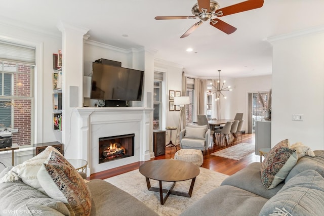 3019 W Cornelia Ave, Chicago, IL 60618 - living area with wood finished floors, crown molding, ceiling fan, a lit fireplace, and a chandelier