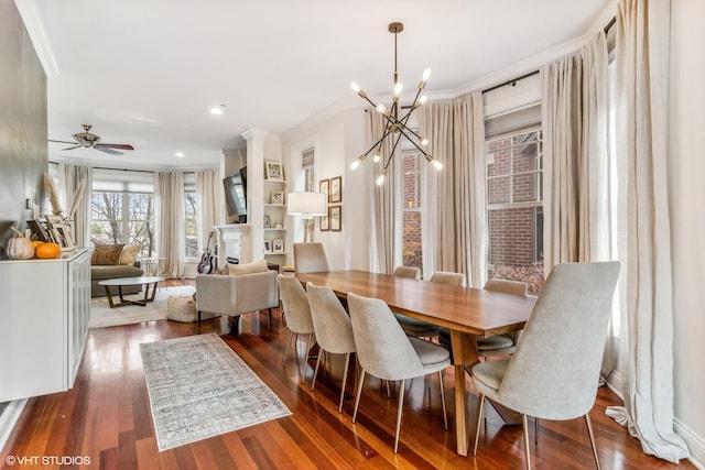 3019 W Cornelia Ave, Chicago, IL 60618 - dining room featuring wood finished floors, a chandelier, ornamental molding, a ceiling fan, and a fireplace