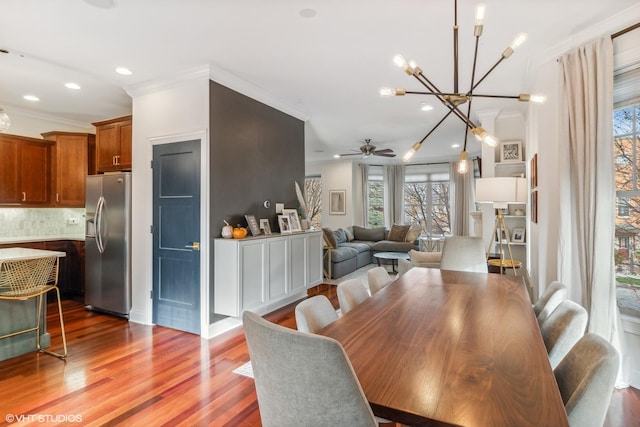 3019 W Cornelia Ave, Chicago, IL 60618 - dining space with a ceiling fan, a chandelier, wood finished floors, ornamental molding, and recessed lighting