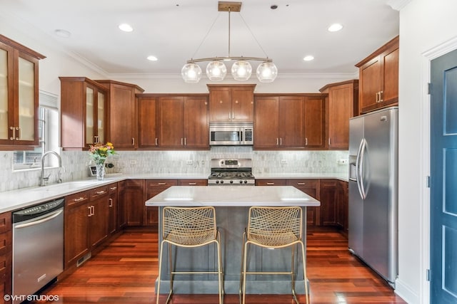 3019 W Cornelia Ave, Chicago, IL 60618 - kitchen with stainless steel appliances, a kitchen island, light countertops, dark wood-type flooring, and glass insert cabinets