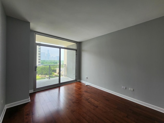 1250 S Michigan Ave Unit 703, Chicago, IL 60605 - spare room with dark wood-style flooring, baseboards, and expansive windows