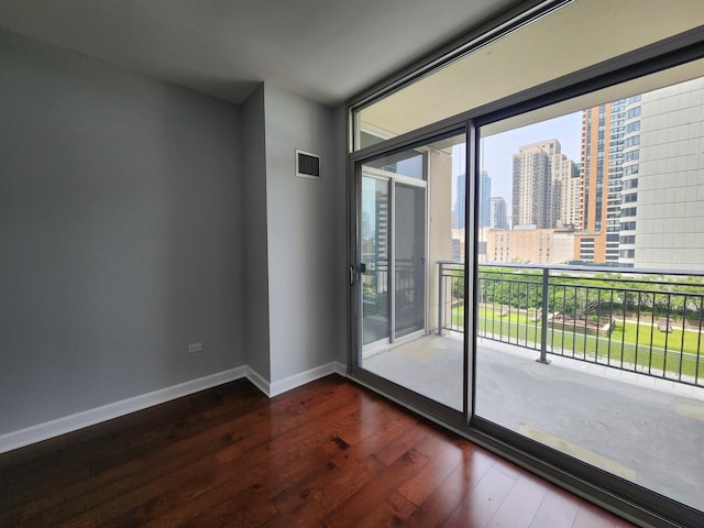 1250 S Michigan Ave Unit 703, Chicago, IL 60605 - empty room with dark wood-style floors and a skyline view