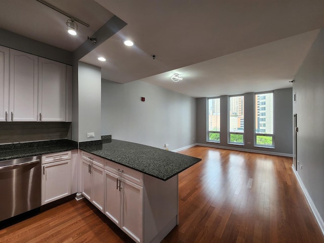 1250 S Michigan Ave Unit 703, Chicago, IL 60605 - kitchen with stainless steel dishwasher, a peninsula, dark wood-style flooring, dark stone countertops, and white cabinets