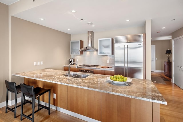 340 E Randolph St Unit 5504, Chicago, IL 60601 - kitchen with stainless steel appliances, wall chimney exhaust hood, light wood-style floors, and recessed lighting