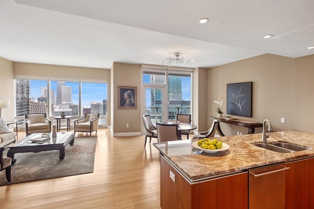 340 E Randolph St Unit 5504, Chicago, IL 60601 - kitchen with plenty of natural light, a skyline view, brown cabinetry, light wood-style flooring, and recessed lighting