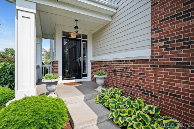 3S661 Breme Dr W, Warrenville, IL 60555 - view of exterior entry featuring brick siding and covered porch