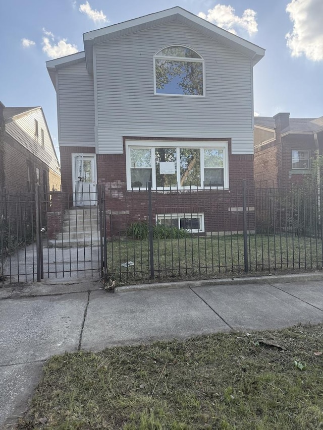 7736 S Oglesby Ave, Chicago, IL 60649 - view of front of home with brick siding, a fenced front yard, and a gate