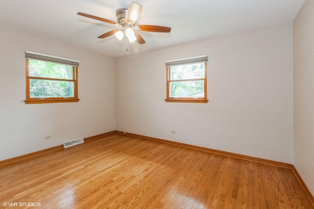 25W251 Highview Dr, Naperville, IL 60563 - spare room with healthy amount of natural light, light wood-type flooring, and ceiling fan