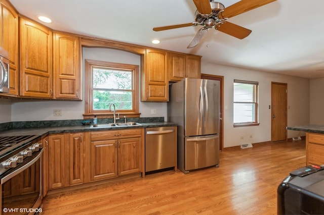 25W251 Highview Dr, Naperville, IL 60563 - kitchen with appliances with stainless steel finishes, dark countertops, light wood-style flooring, ceiling fan, and recessed lighting