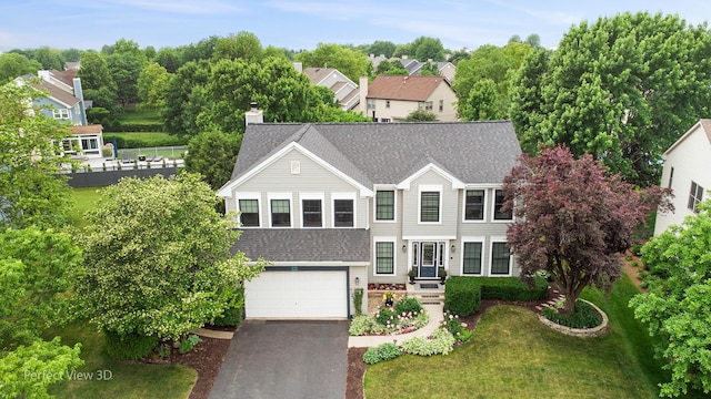 1860 Haverford Dr, Algonquin, IL 60102 - traditional-style home featuring a garage, a shingled roof, asphalt driveway, and a front lawn