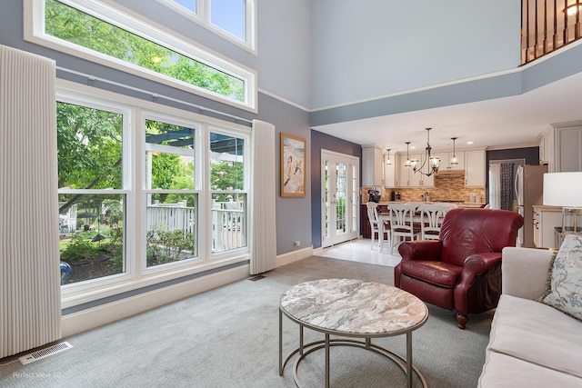 1860 Haverford Dr, Algonquin, IL 60102 - living area featuring a towering ceiling, light colored carpet, a chandelier, and french doors