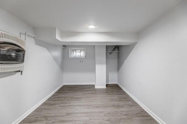 basement with wood finished floors and baseboards