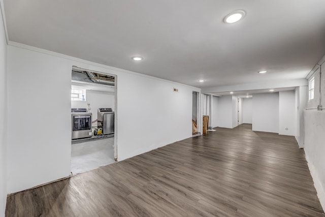 basement featuring wood finished floors, recessed lighting, and washer / dryer