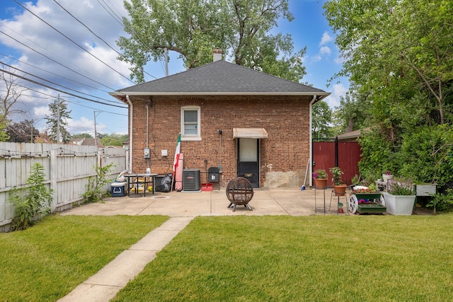 back of house featuring a patio area, roof with shingles, and brick siding