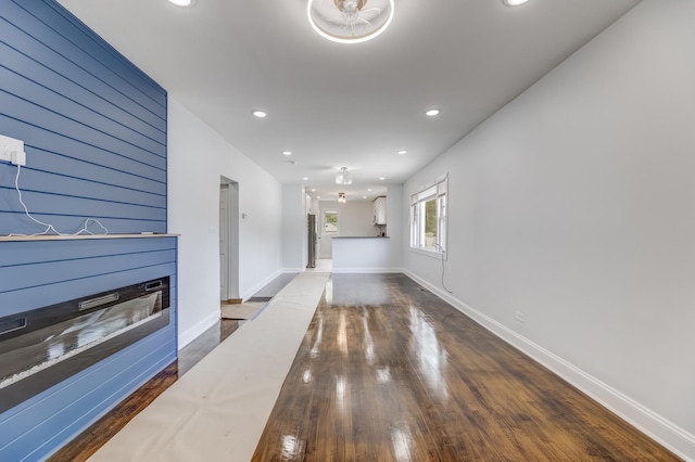 unfurnished living room with a glass covered fireplace, hardwood / wood-style flooring, and recessed lighting