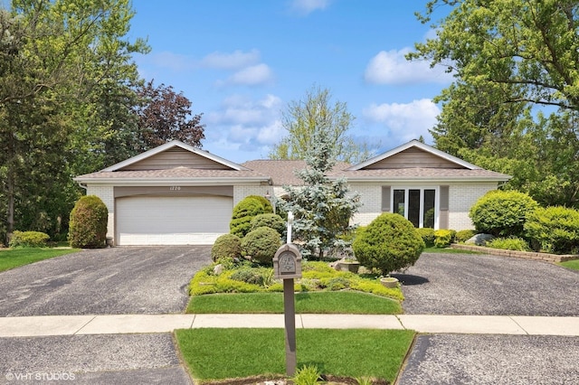 1770 Overland Trl, Deerfield, IL 60015 - ranch-style home with brick siding, driveway, a garage, and roof with shingles