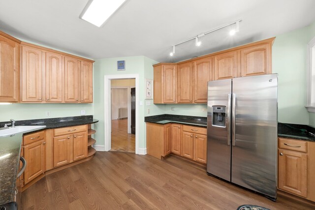 5010 N California Ave, Chicago, IL 60625 - kitchen with stainless steel fridge, rail lighting, wood finished floors, and dark stone counters