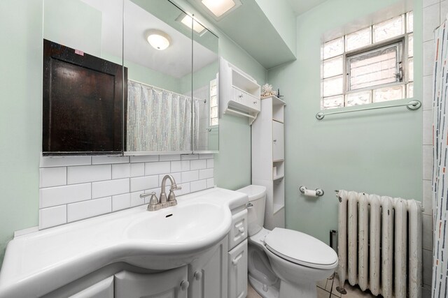 5010 N California Ave, Chicago, IL 60625 - bathroom featuring radiator heating unit, decorative backsplash, vanity, and curtained shower