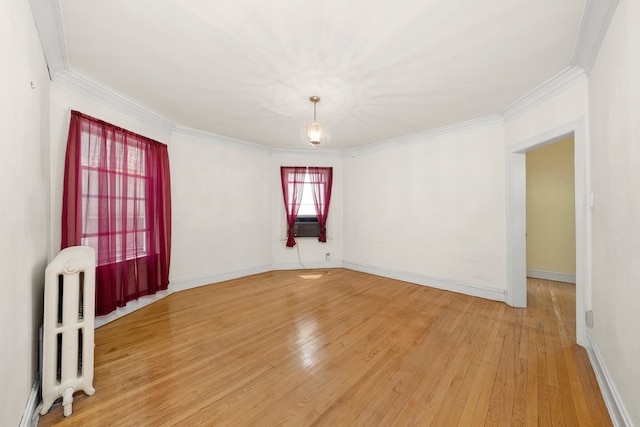 5010 N California Ave, Chicago, IL 60625 - unfurnished room featuring radiator, light wood finished floors, and crown molding